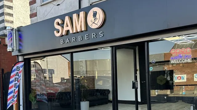 The shop window and barber pole at SAM Barbers